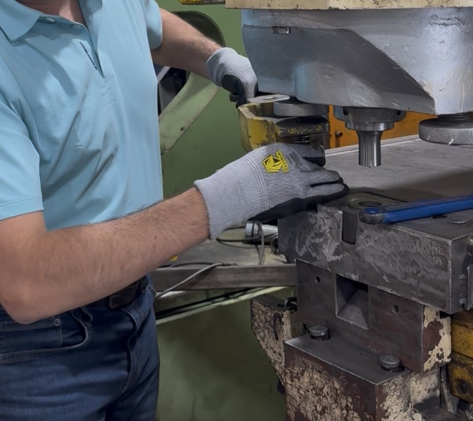 Technician servicing metal fabrication equipment